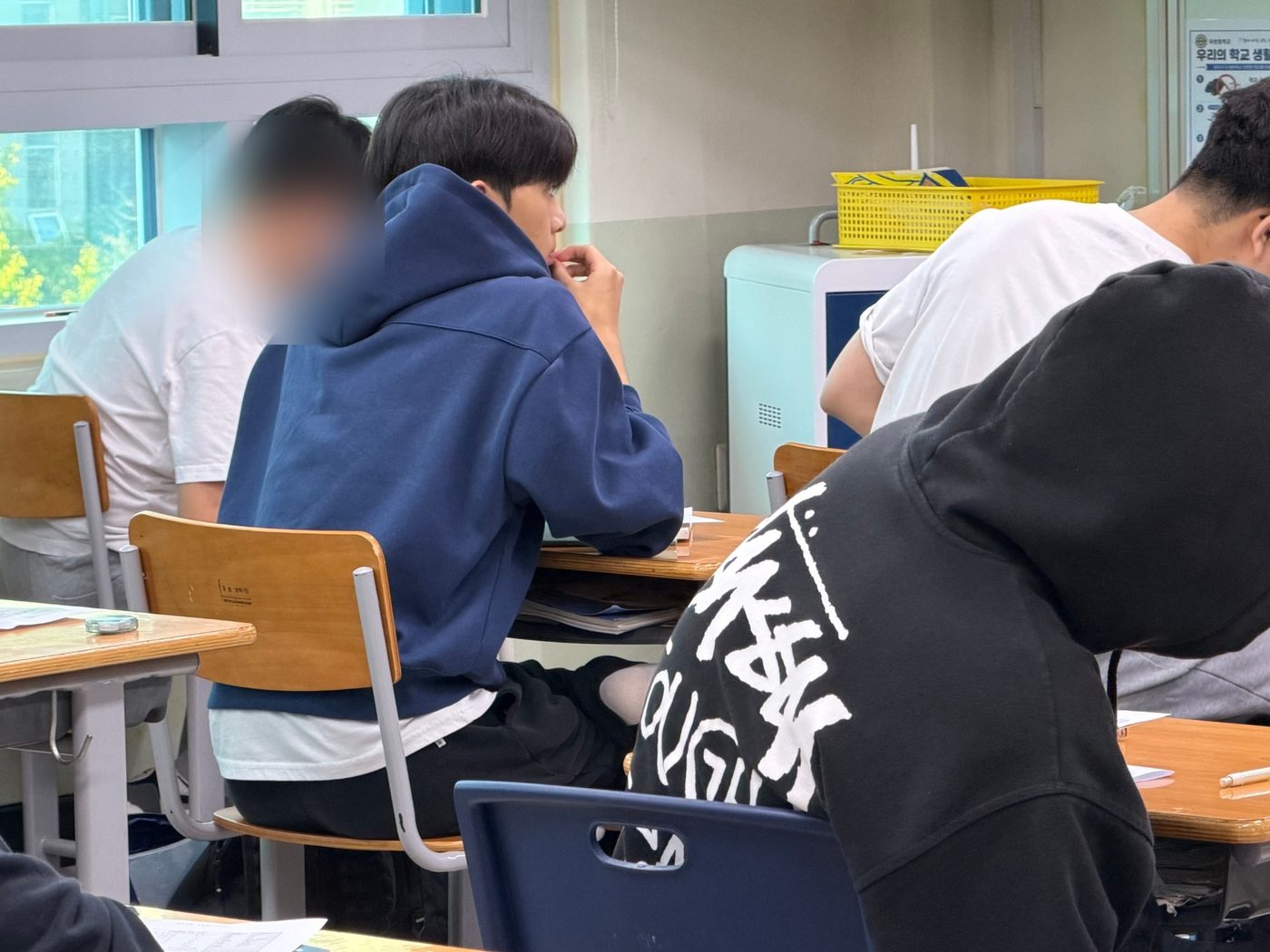 창가 자리에서 시험 시작을 기다리는 수험생